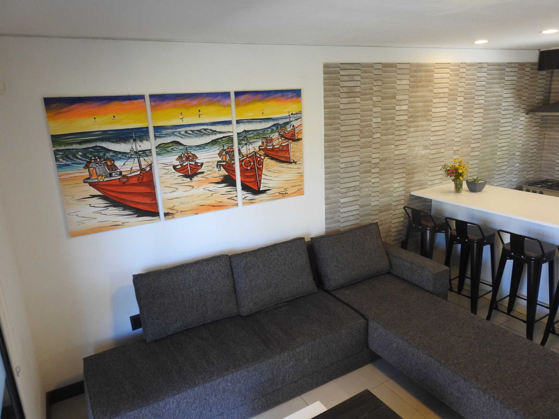 A living room with a couch and a painting on the wall