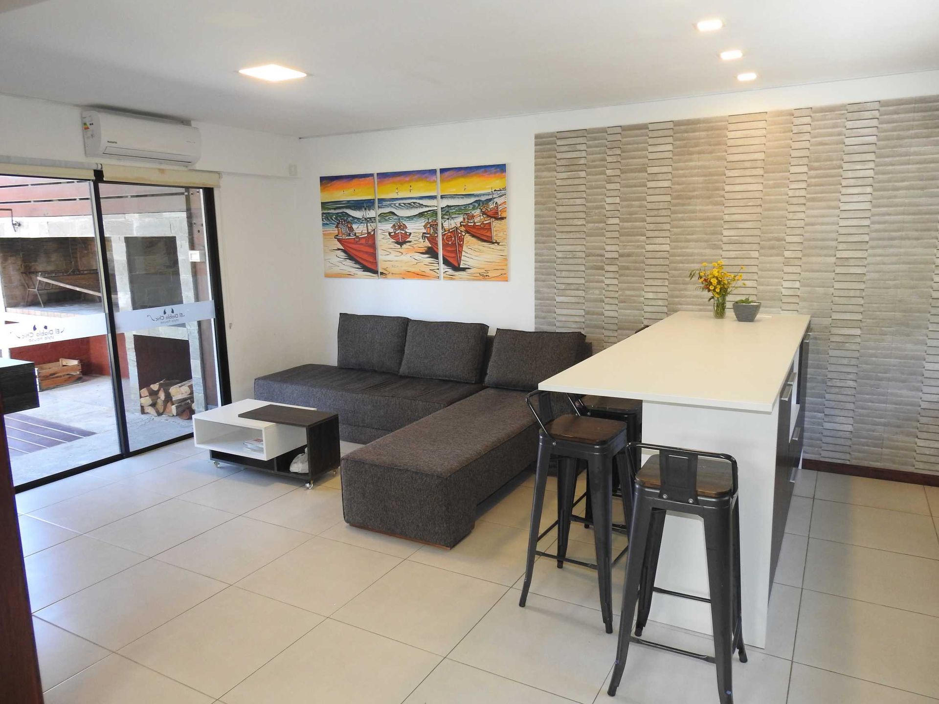 A living room with a couch , table and stools