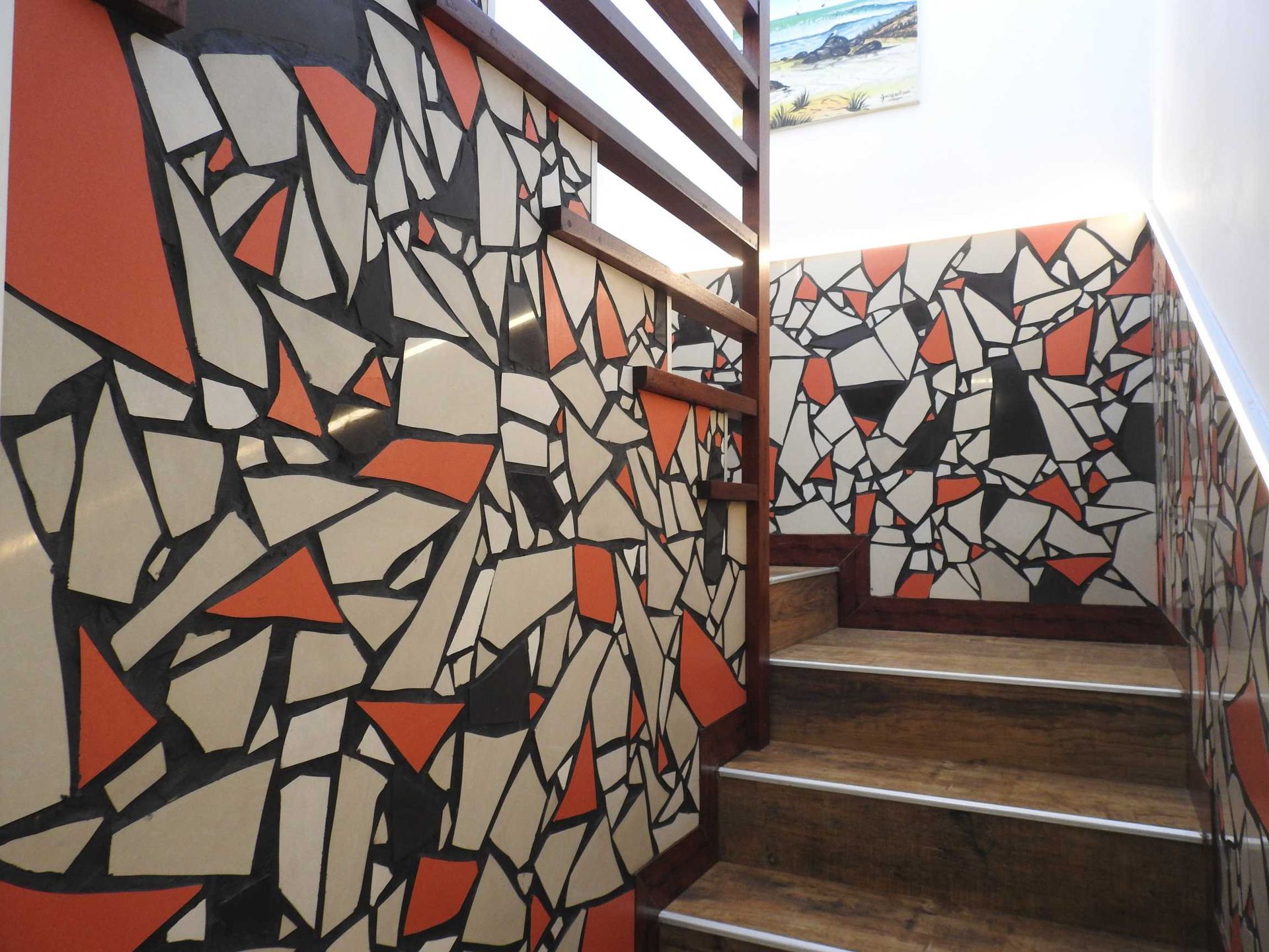 A staircase with a geometric pattern on the wall
