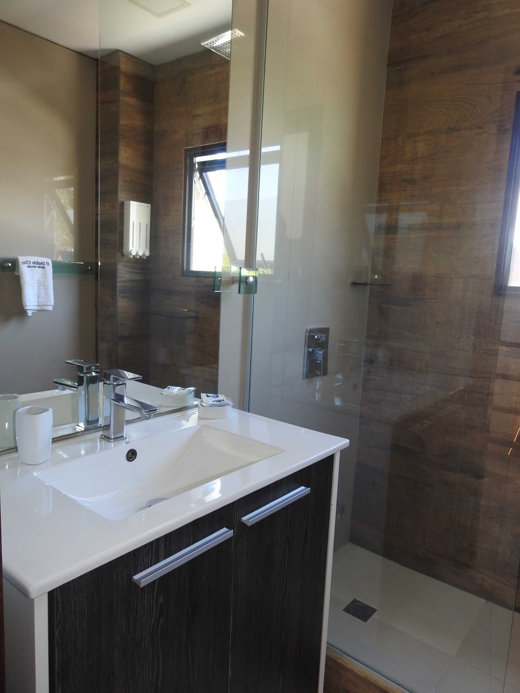 A bathroom with a sink and a walk in shower
