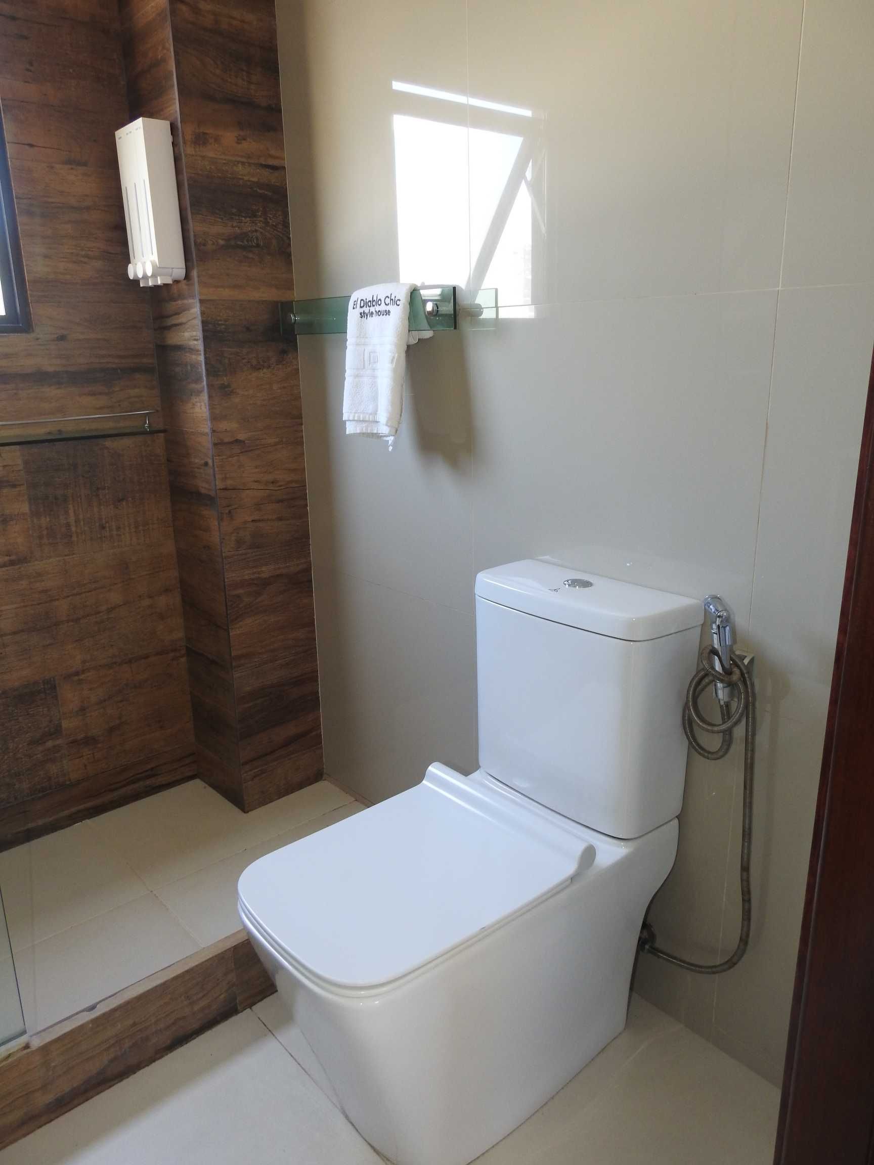 A bathroom with a toilet and a shower.