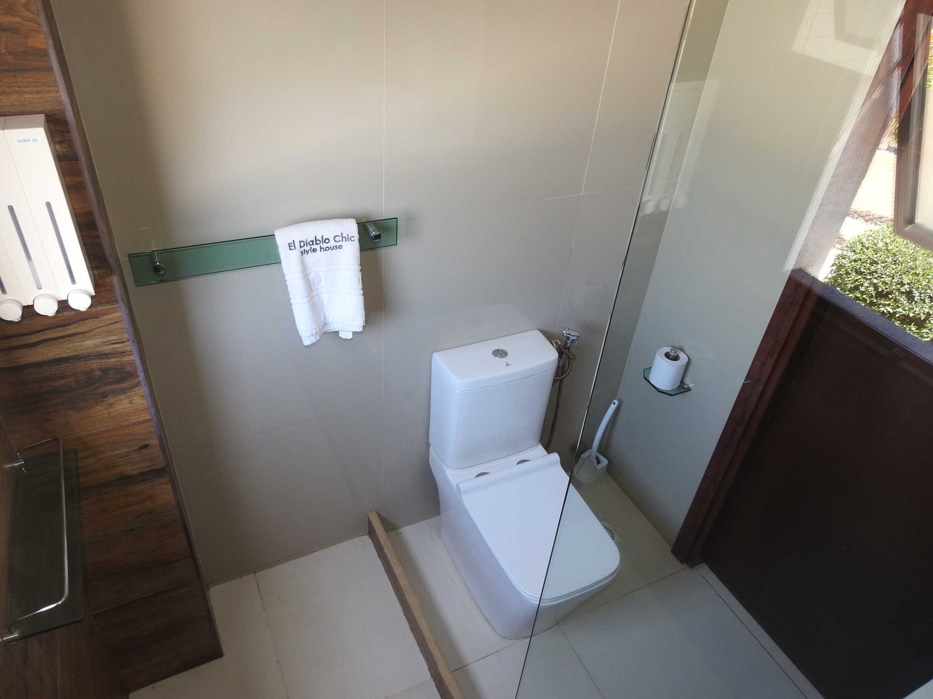 A bathroom with a toilet and a shower stall
