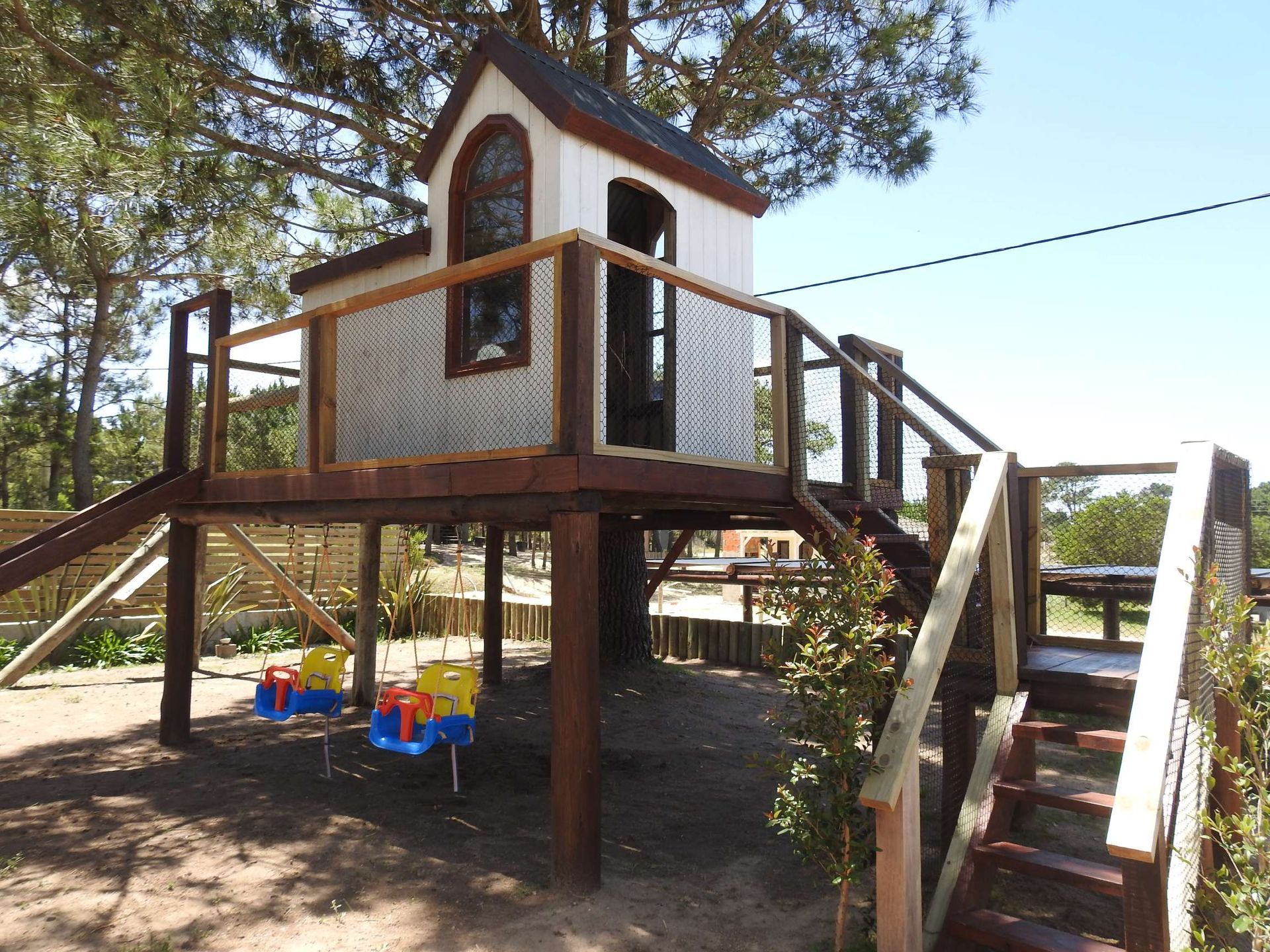 A tree house with stairs leading up to it