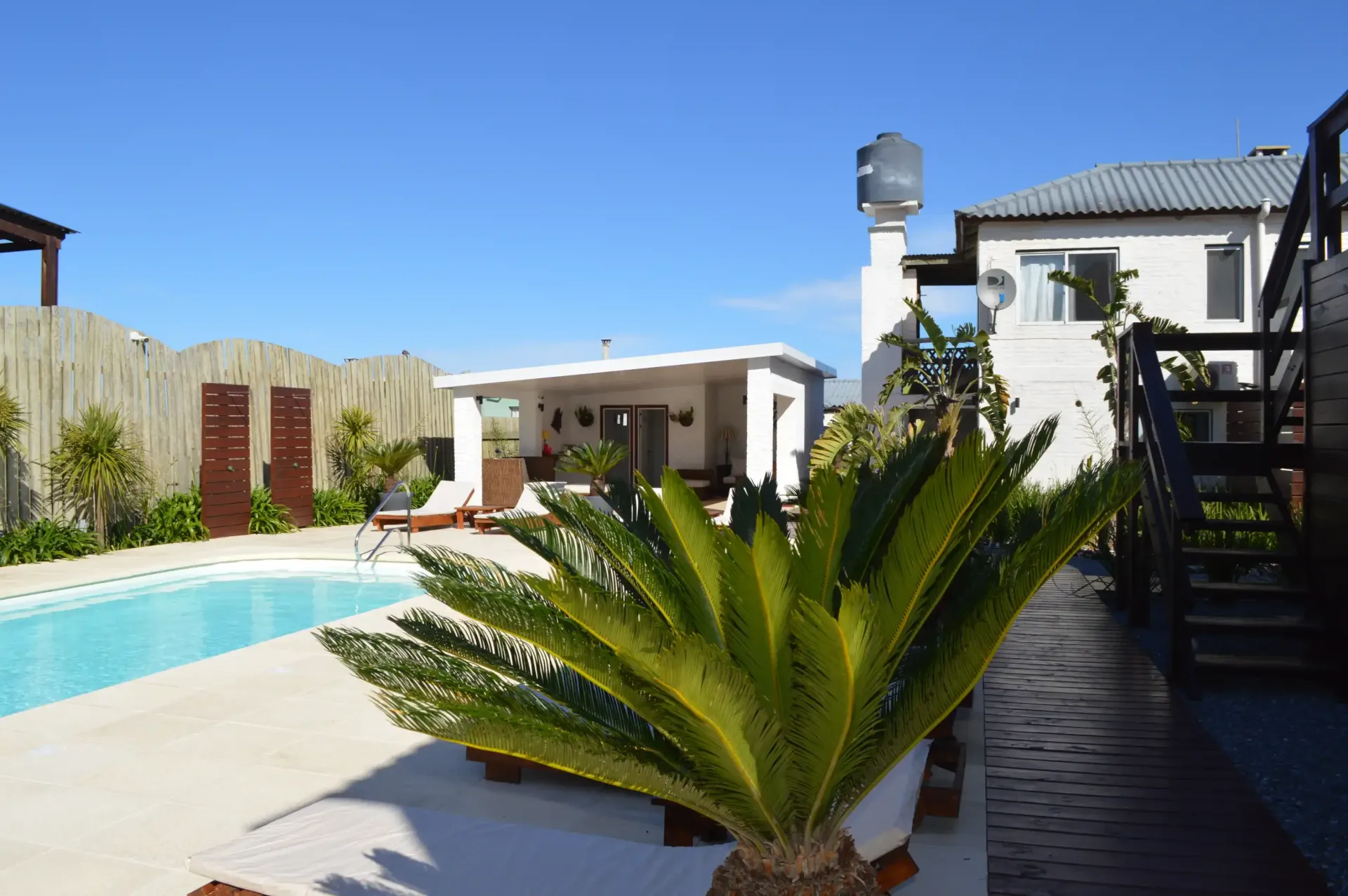 A house with a swimming pool in front of it