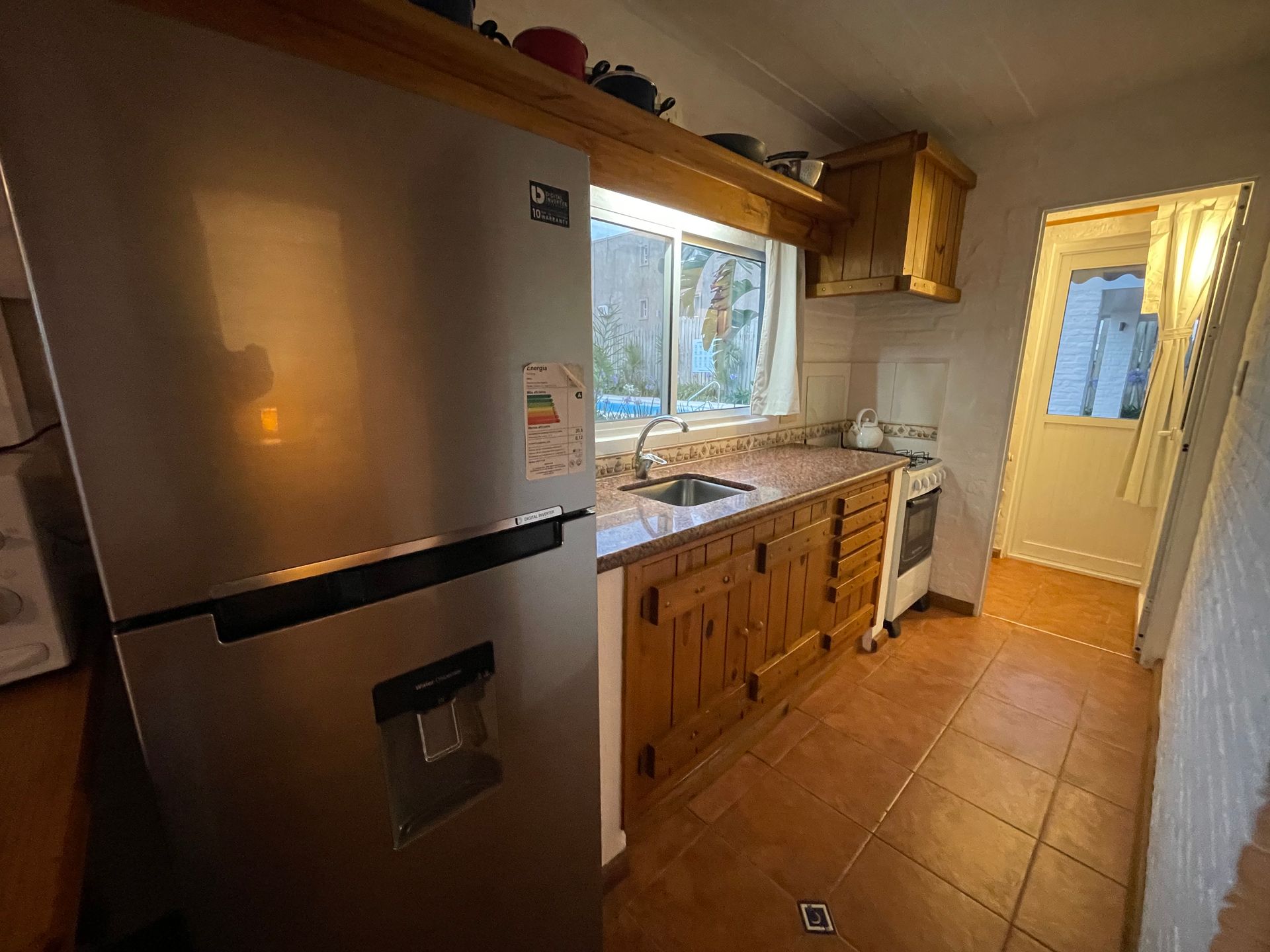 A kitchen with stainless steel appliances and wooden cabinets.