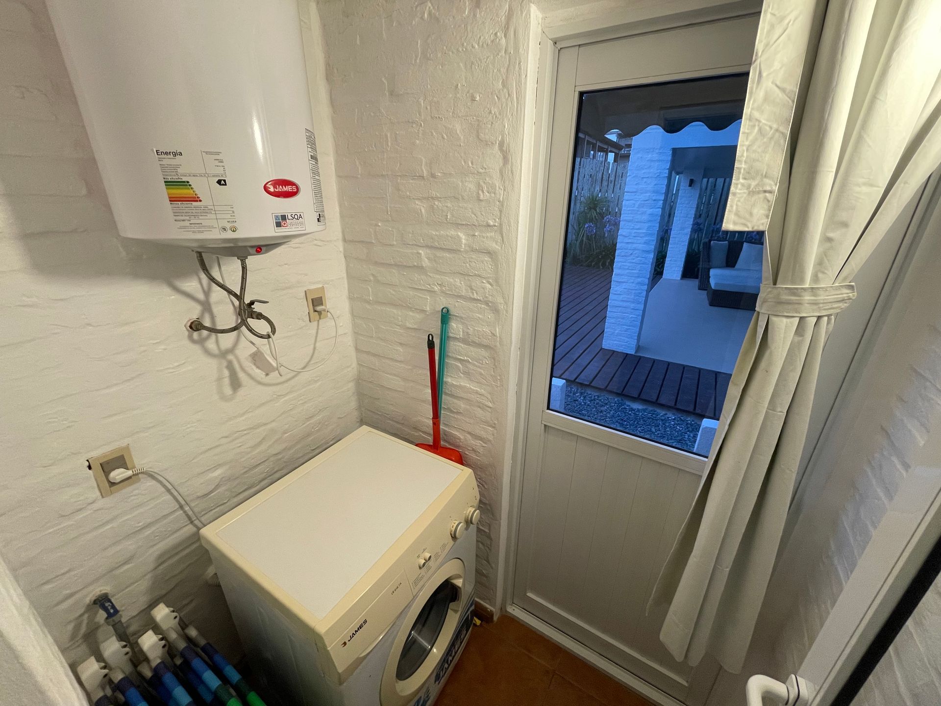 A laundry room with a washer and dryer and a water heater.
