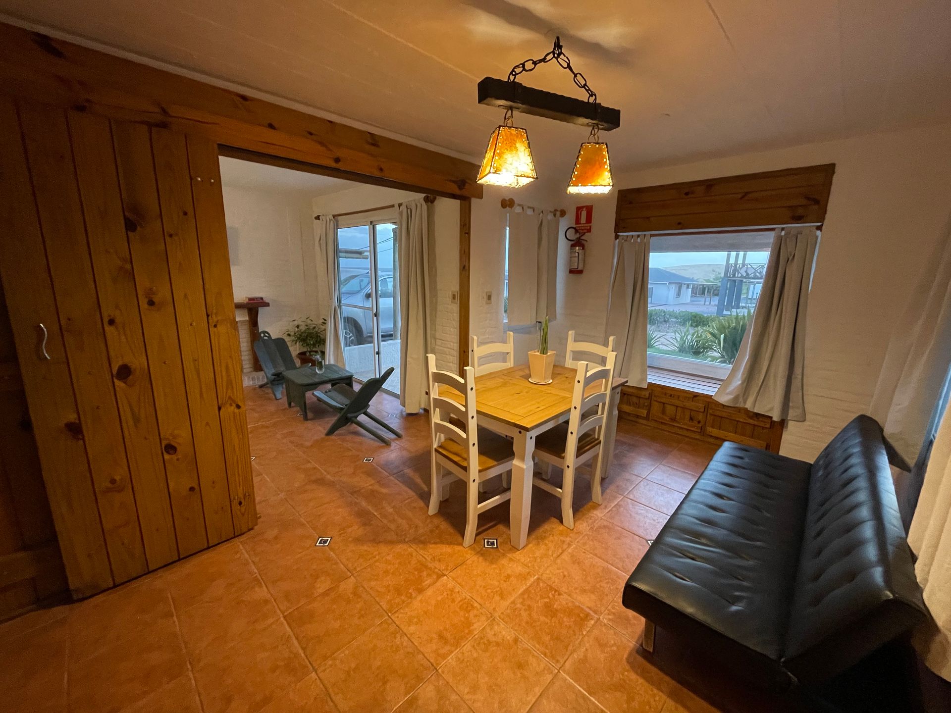 A living room with a table and chairs and a couch.