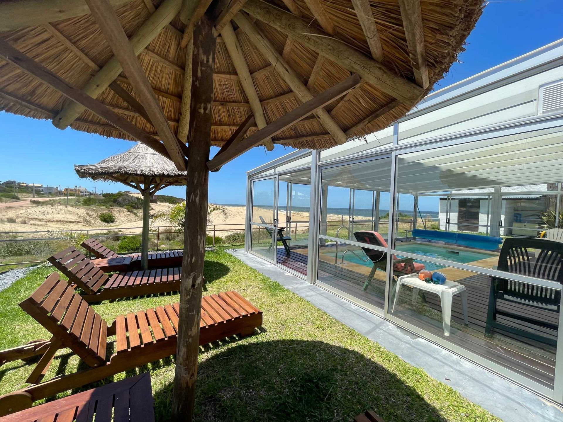 A swimming pool with chairs and umbrellas in front of it
