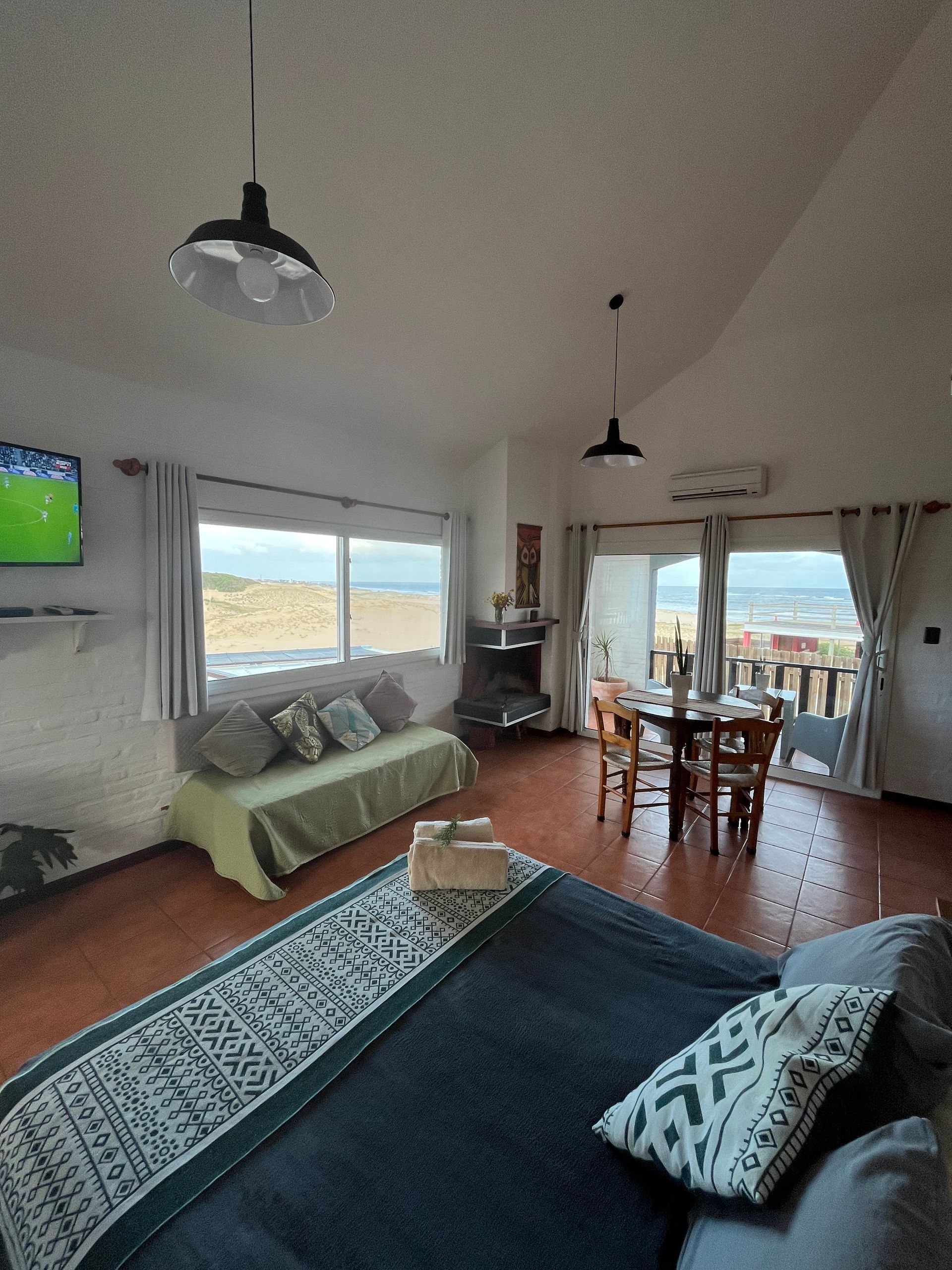 A living room with a couch , table , chairs and a television.