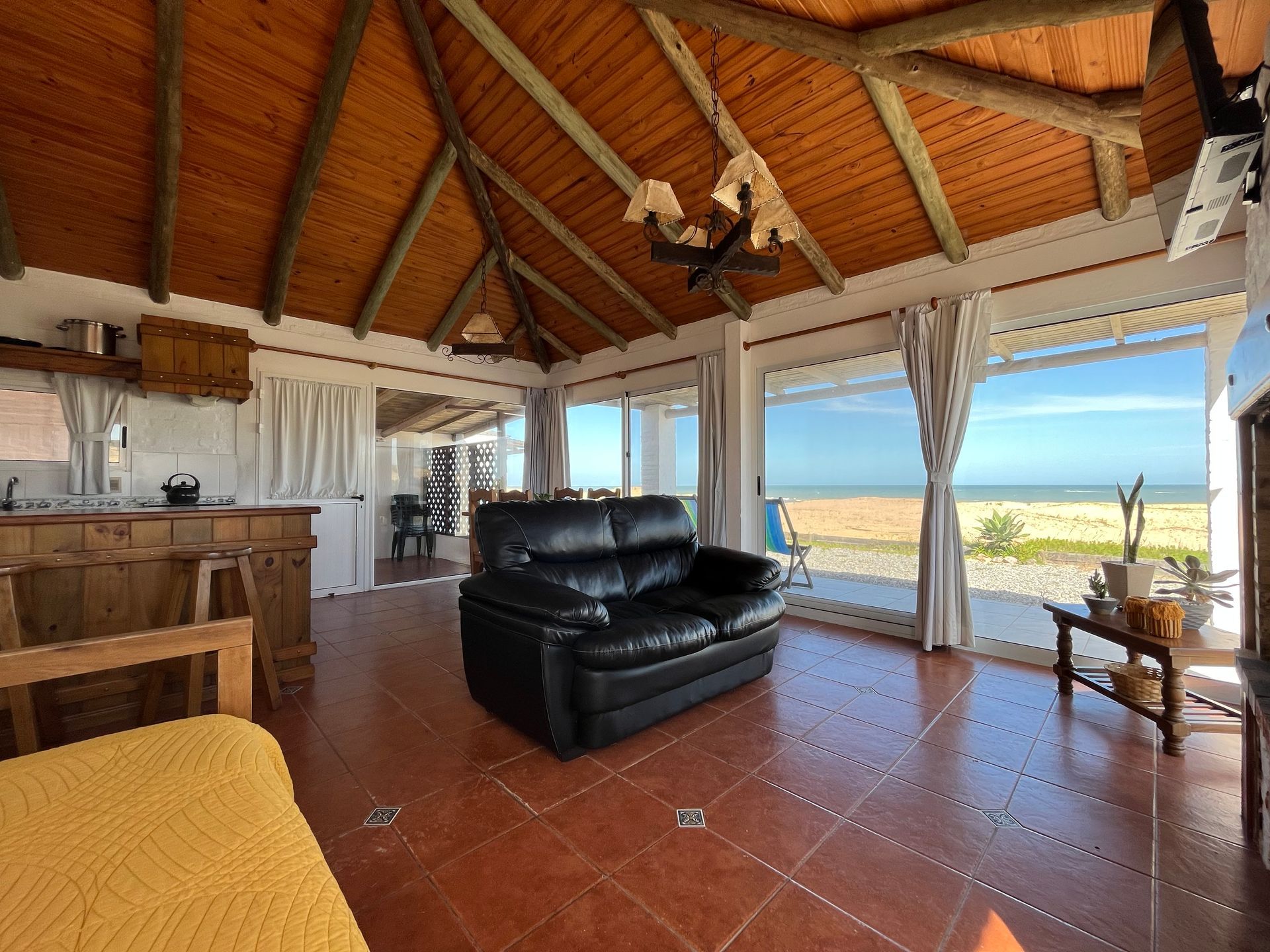 A living room with a couch and a view of the ocean.