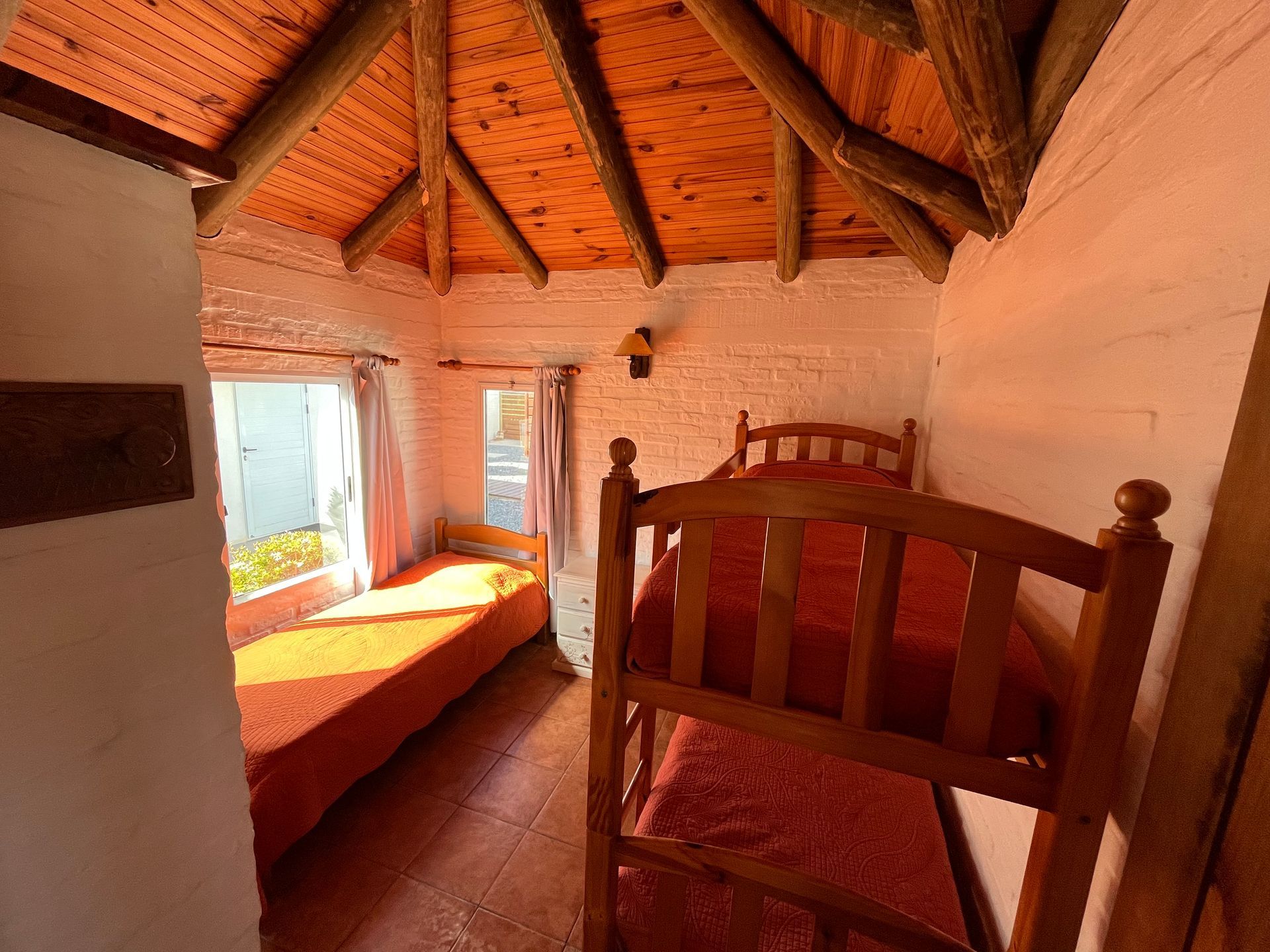 A bedroom with a bunk bed and a single bed