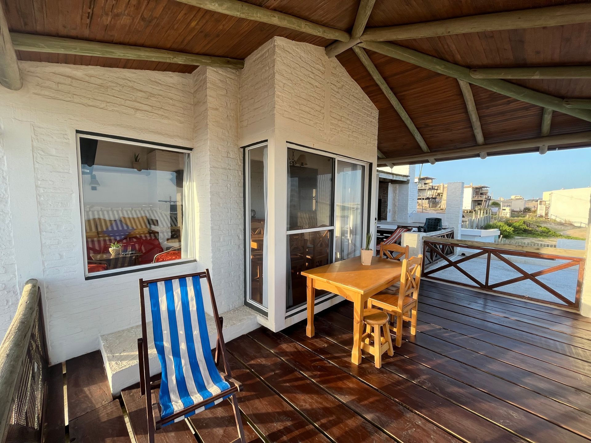 A wooden deck with a table and chairs on it.
