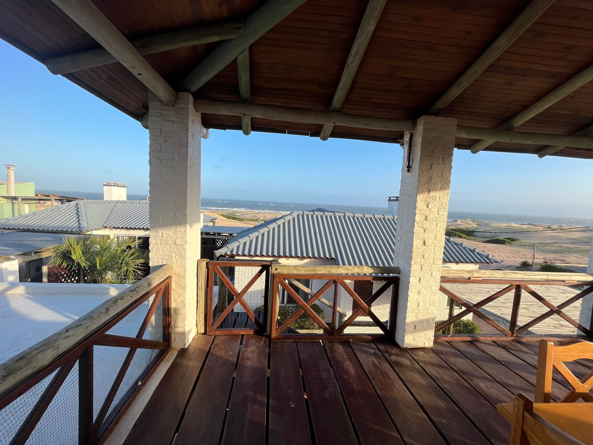 A wooden deck with a view of the ocean