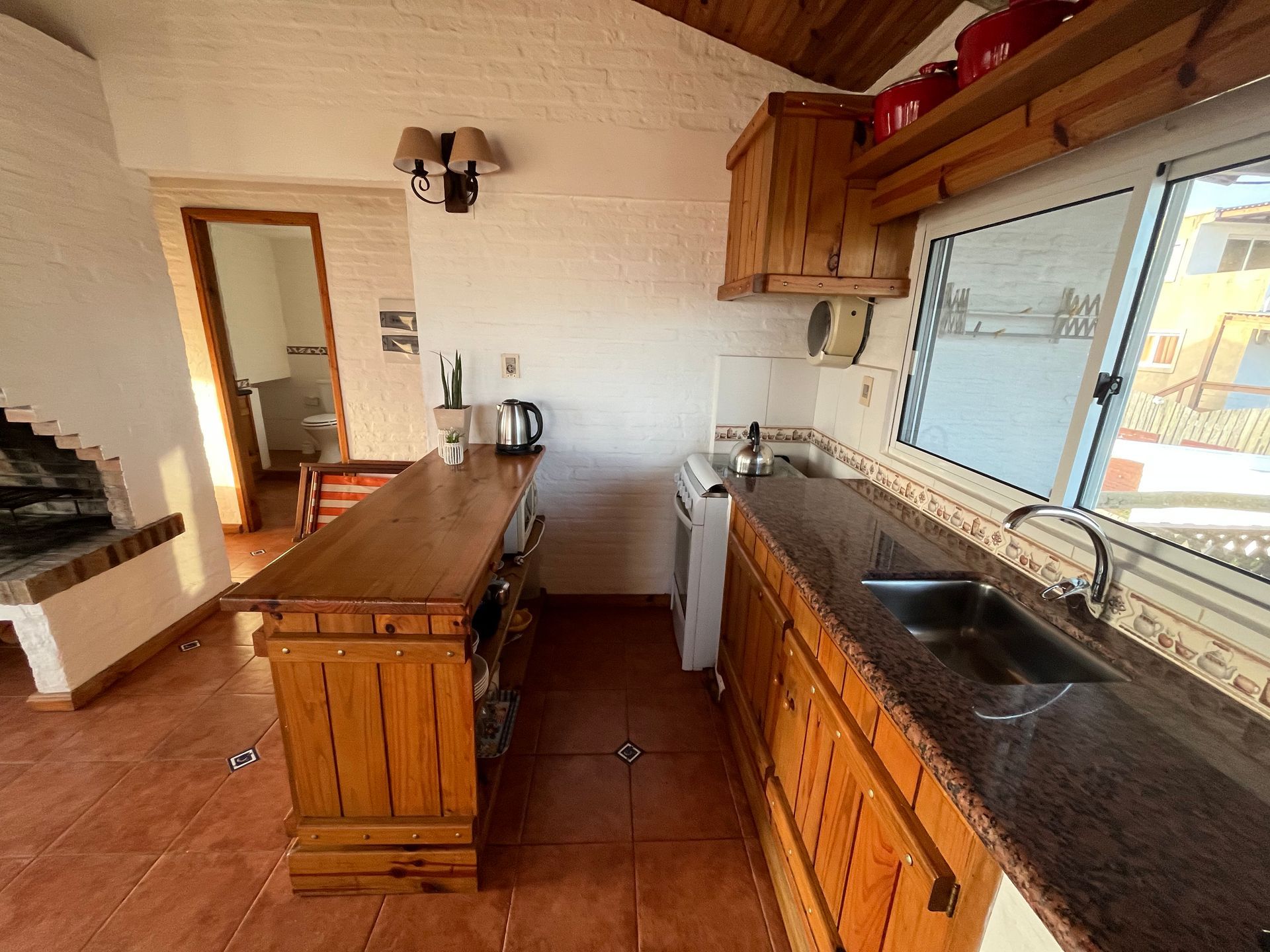 A kitchen with wooden cabinets and granite counter tops