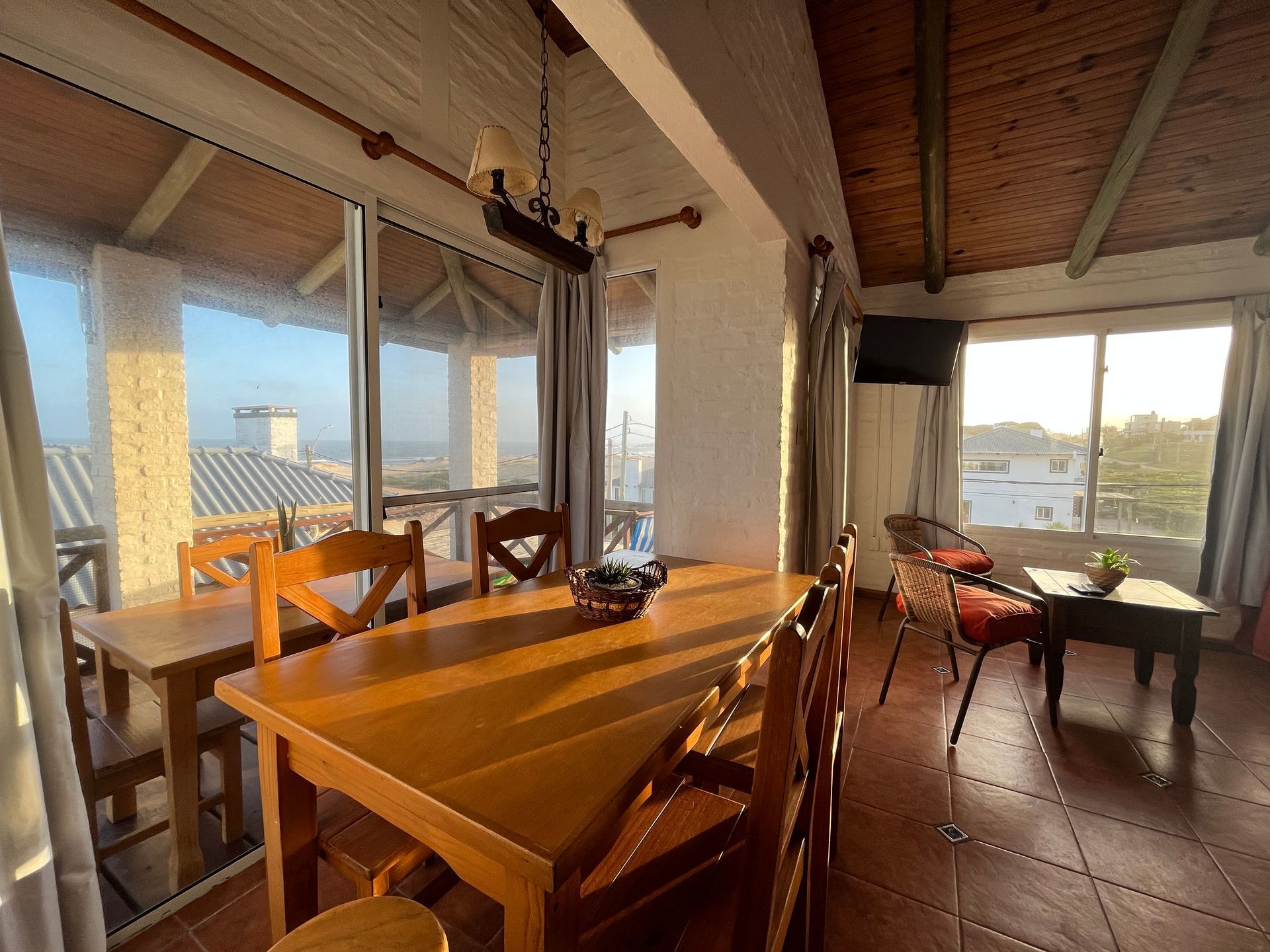 A living room with a wooden table and chairs