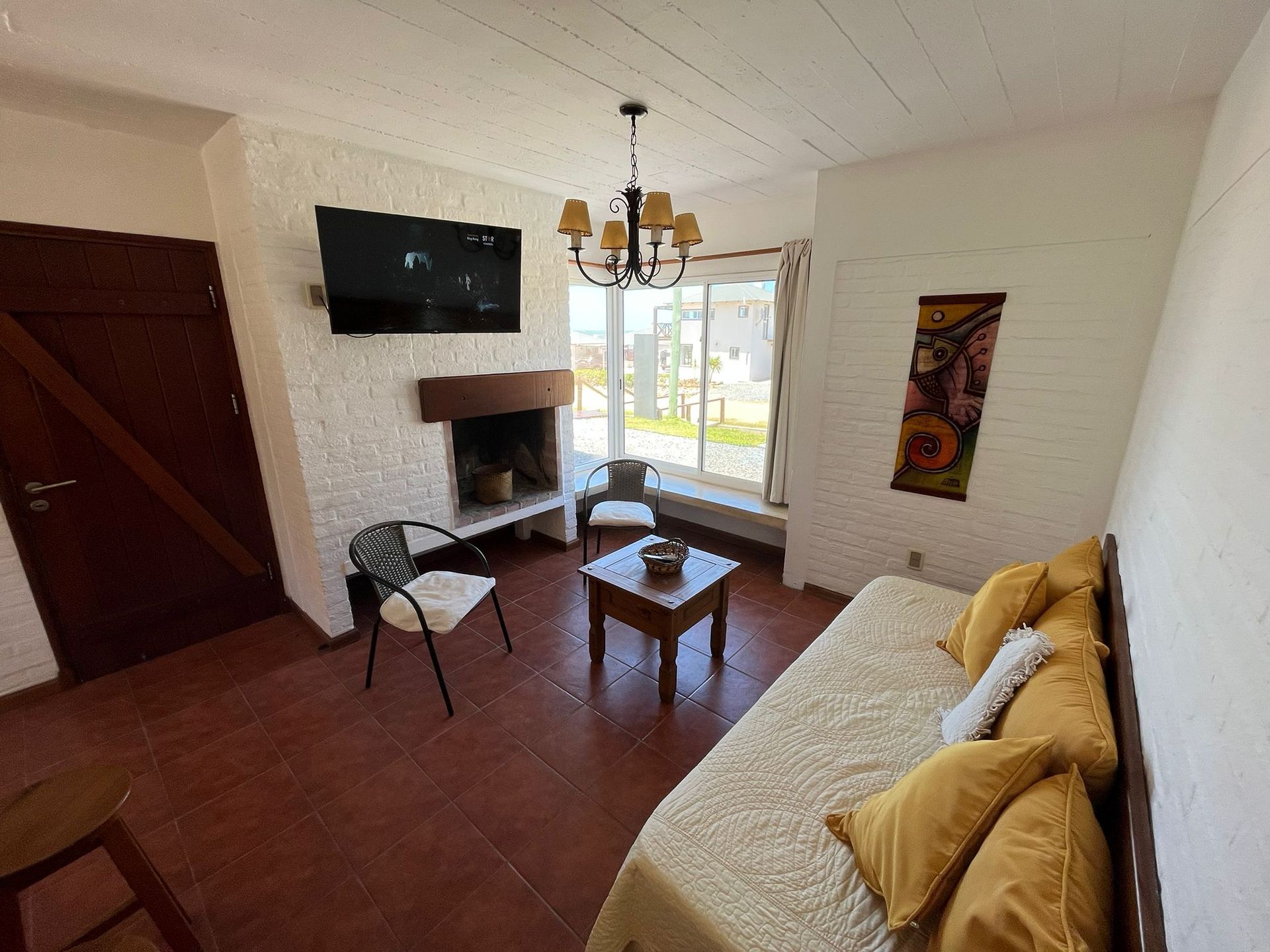 A living room with a fireplace and a flat screen tv