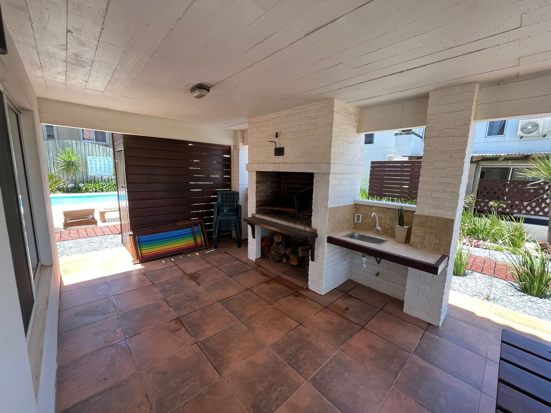 A patio with a grill and a sink in it