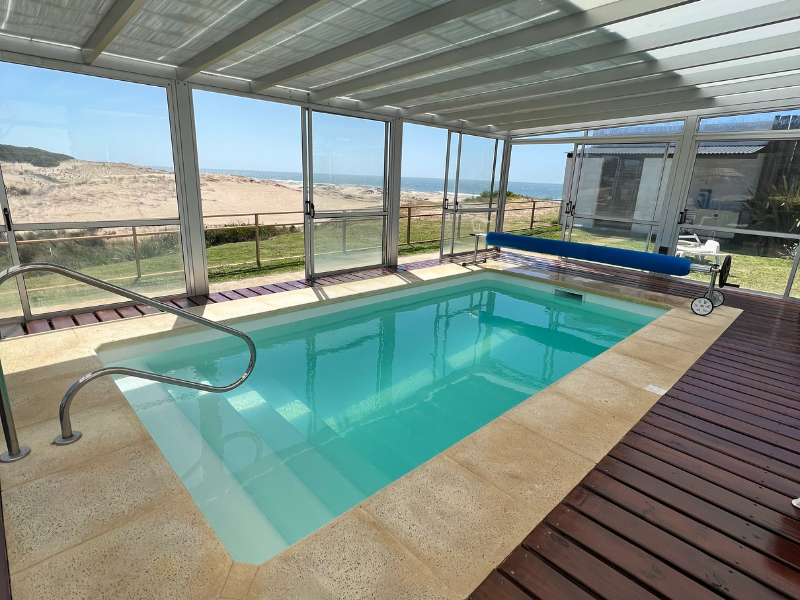 A large indoor swimming pool with a view of the ocean