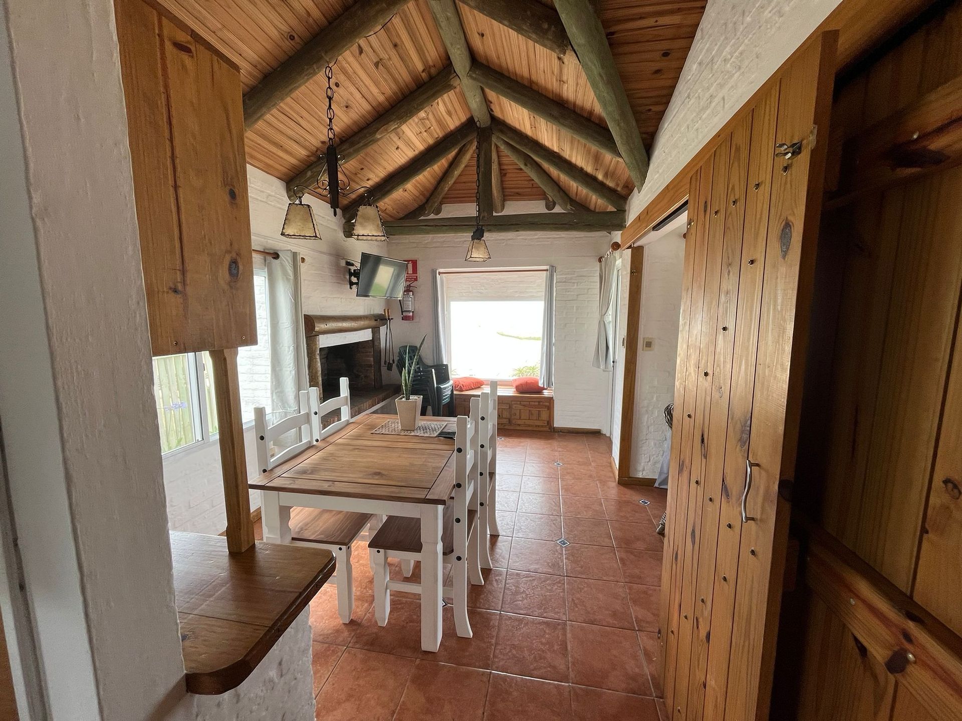 A dining room with a wooden table and chairs