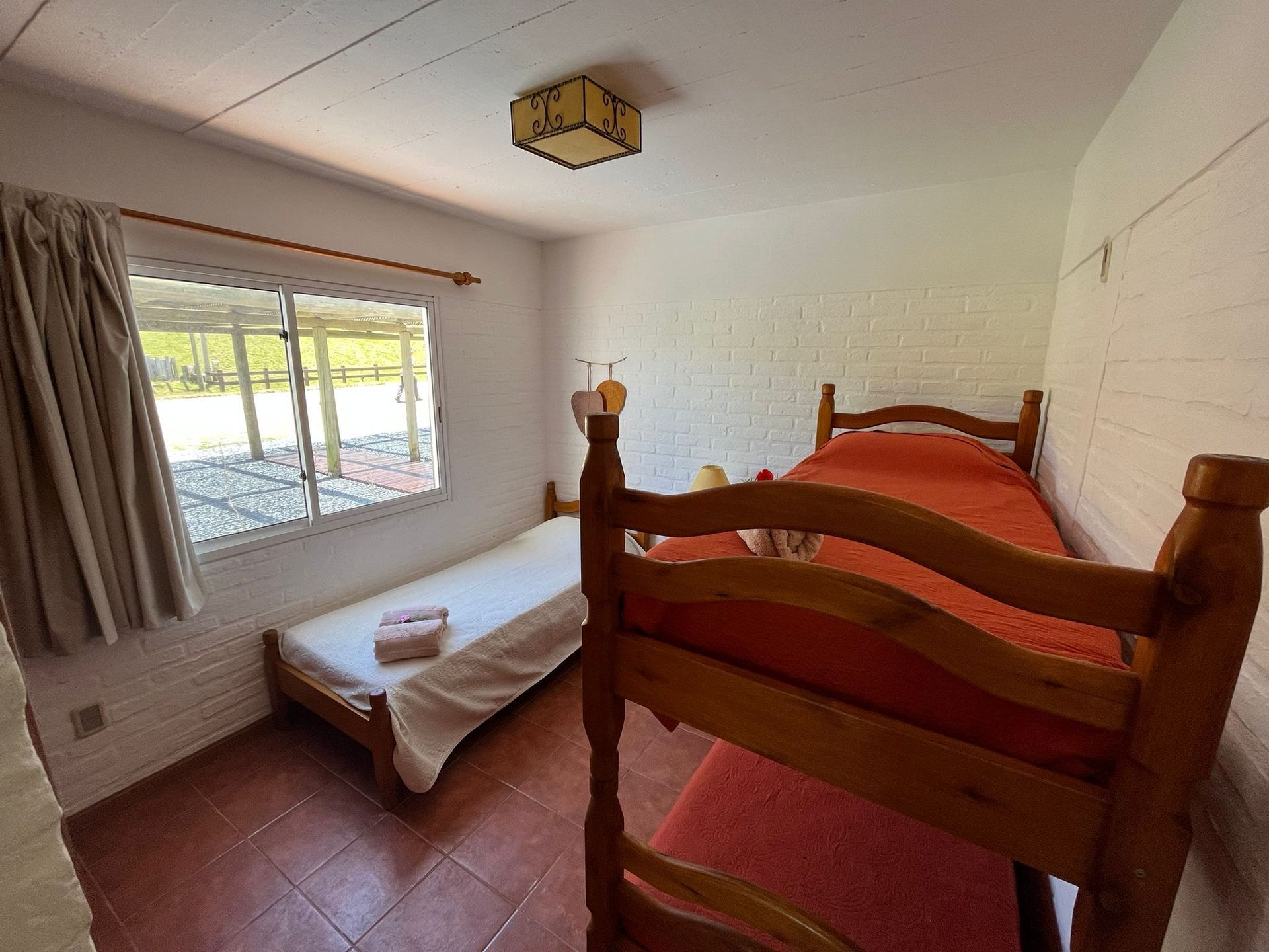 A bedroom with a bunk bed and a single bed