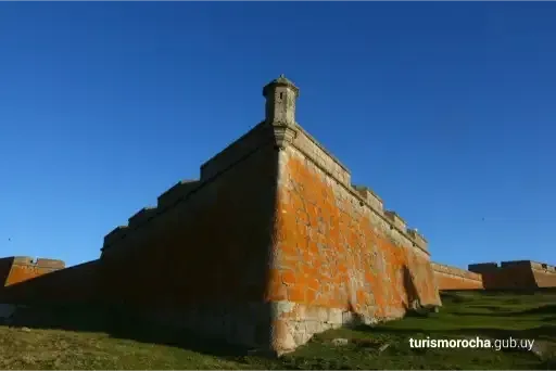 A large orange building with a blue sky in the background