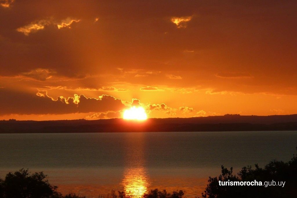 The sun is setting over a body of water.