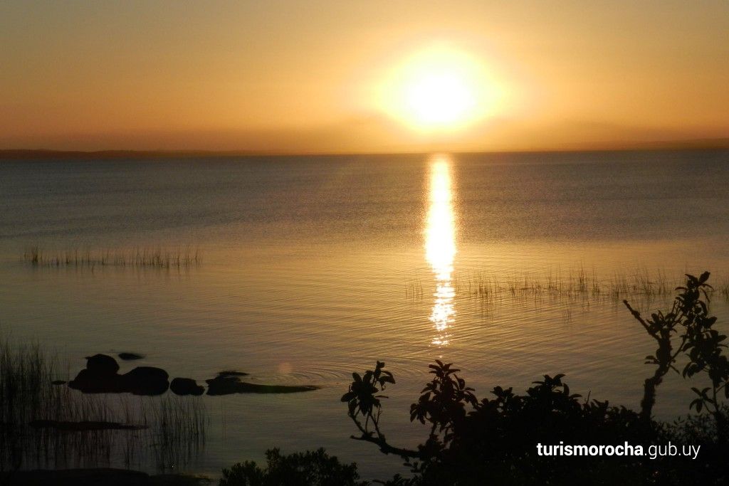 The sun is setting over a body of water
