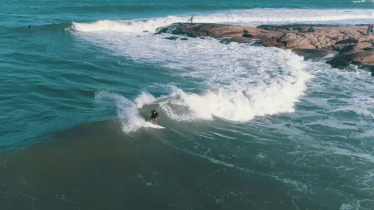 A person is riding a wave on a surfboard in the ocean.