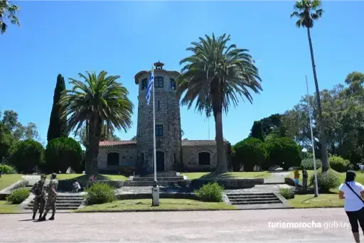A stone building with palm trees in front of it