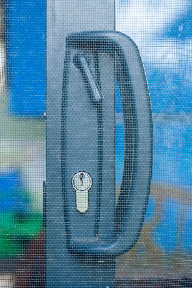 Gray Sliding Door Handle With a Small Latch and a Keyhole — Suburban Security Screens in Currumbin, QLD