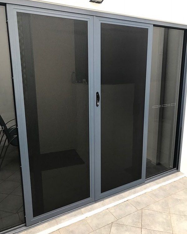 A Sliding Door With a Dark, Fine-mesh Screen Installed in a Grey Frame — Suburban Security Screens in Currumbin, QLD