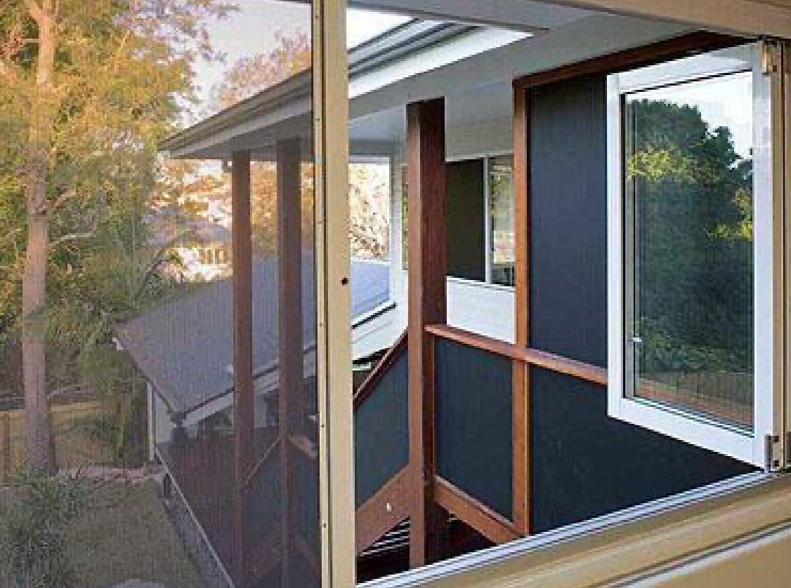 A View from A Window Looking out Onto a Wooden Deck — Suburban Security Screens in Currumbin, QLD