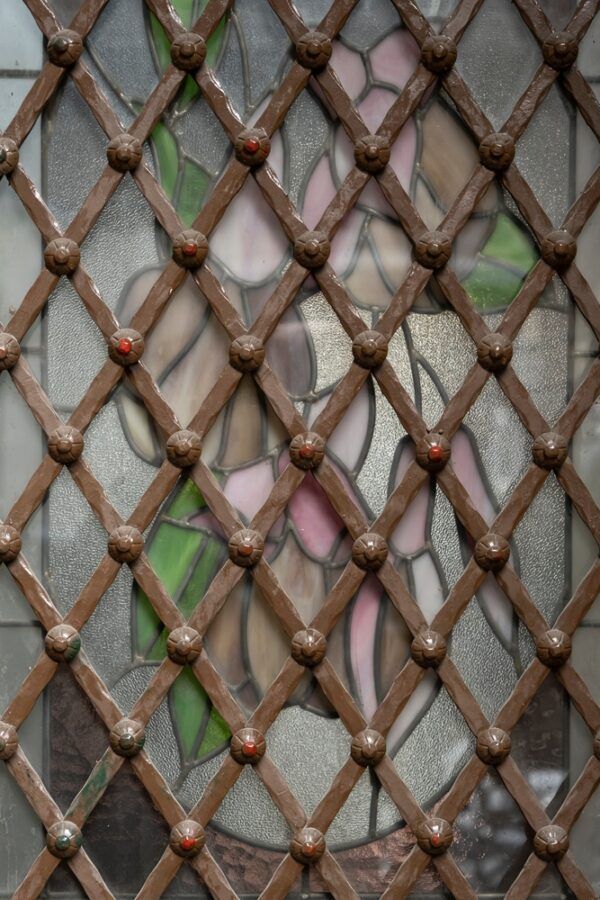 Metal Lattice Grill Overlaying a Window — Suburban Security Screens in Currumbin, QLD