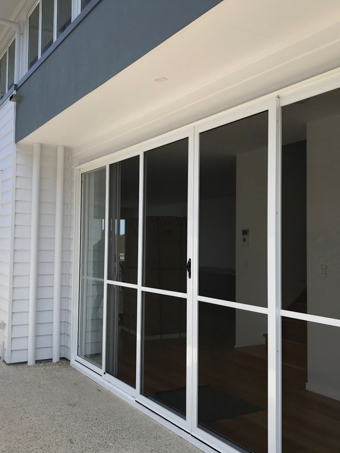 A Set of White-Framed Sliding Screen Doors Installed on A Patio — Suburban Security Screens in Currumbin, QLD