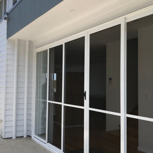 White Sliding Screen Door Installed on the Exterior of a Home — Suburban Security Screens in Currumbin, QLD
