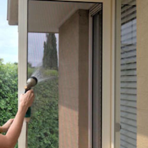Person Holding a Handheld Showerhead — Suburban Security Screens in Currumbin, QLD