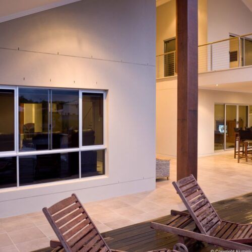 Two Wooden Lounge Chairs on a Patio — Suburban Security Screens in Currumbin, QLD