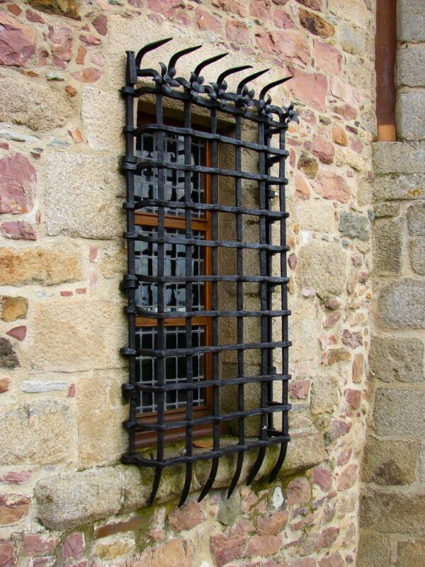 A Stone Building Exterior with A Barred — Suburban Security Screens in Currumbin, QLD