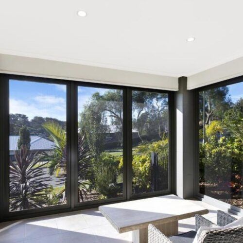 Indoor Patio With Large Black-framed Glass Sliding Doors — Suburban Security Screens in Currumbin, QLD