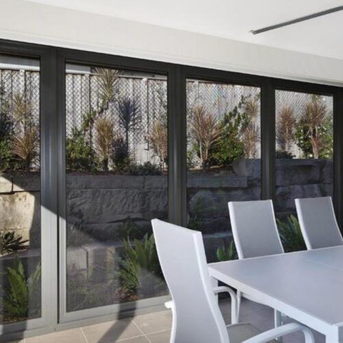 Bright Dining Area Featuring a Modern Table and Chairs — Suburban Security Screens in Currumbin, QLD