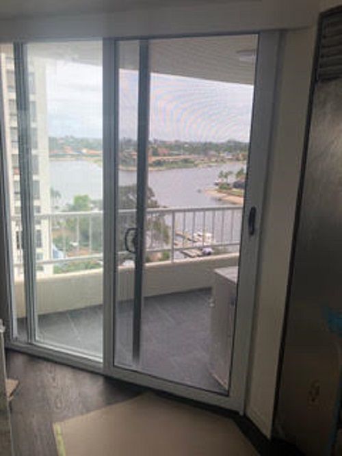 A View from Inside Through a Sliding Glass Door — Suburban Security Screens in Currumbin, QLD