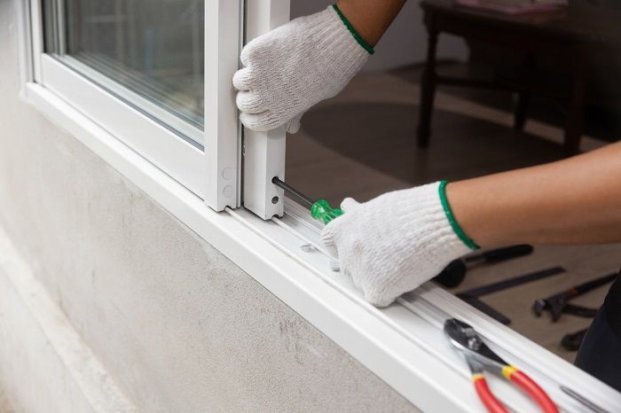 Hands Wearing White Work Gloves Use a Screwdriver — Suburban Security Screens in Currumbin, QLD