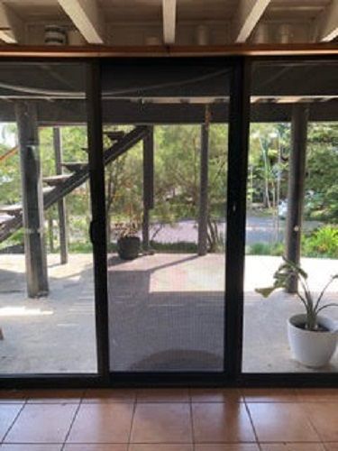 A View from Inside Through a Glass Sliding Door — Suburban Security Screens in Currumbin, QLD