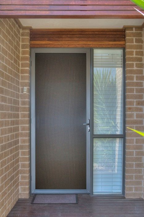 A Dark Brown Modern Front Door with A Side Glass Panel — Suburban Security Screens in Currumbin, QLD