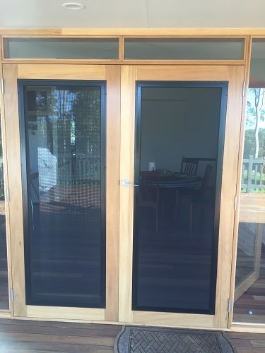 A Set of Double Doors with Light Wood Frames — Suburban Security Screens in Currumbin, QLD