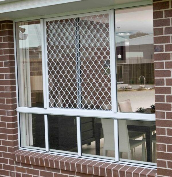 Window Set in a Brown Brick Wall, Featuring a White Frame — Suburban Security Screens in Currumbin, QLD