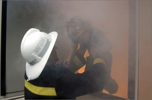 Firefighter in a White Helmet Carries a Child — Suburban Security Screens in Currumbin, QLD