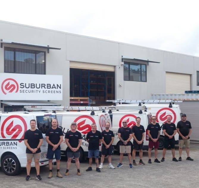 Team of People in Branded Shirts Standing — Suburban Security Screens in Currumbin, QLD