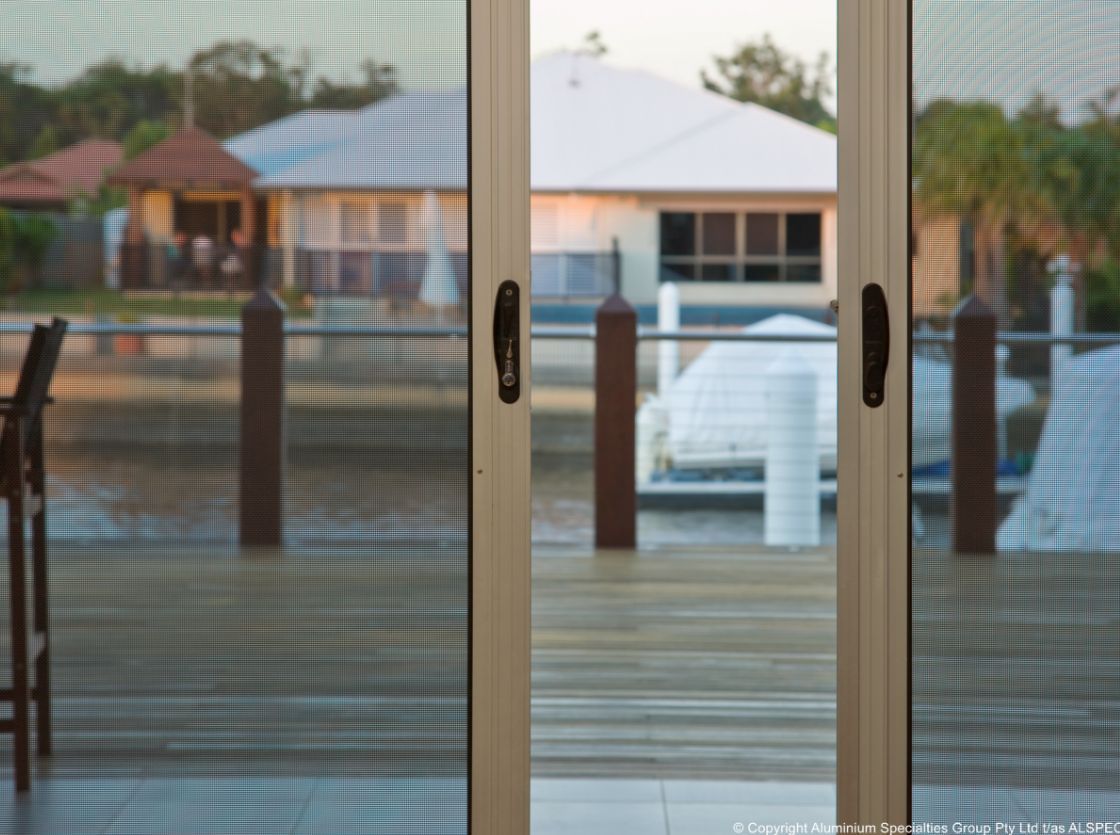 View From Inside Looking Through a Glass Sliding Door — Suburban Security Screens in Currumbin, QLD