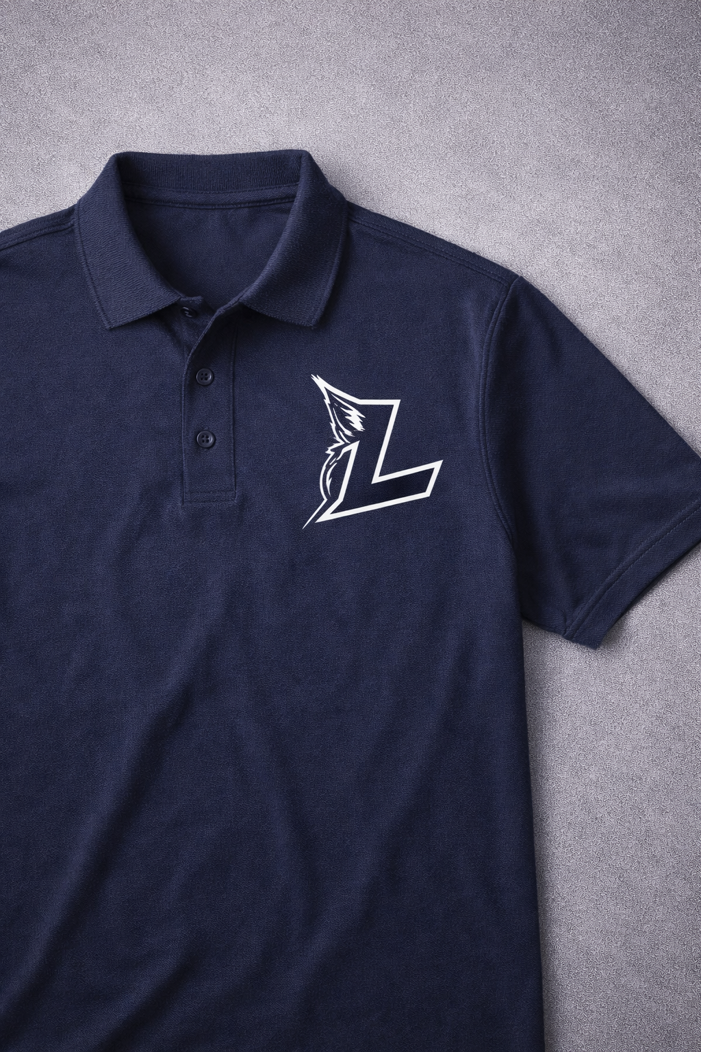 Navy polo shirt with white embroidered “L” logo on a gray background